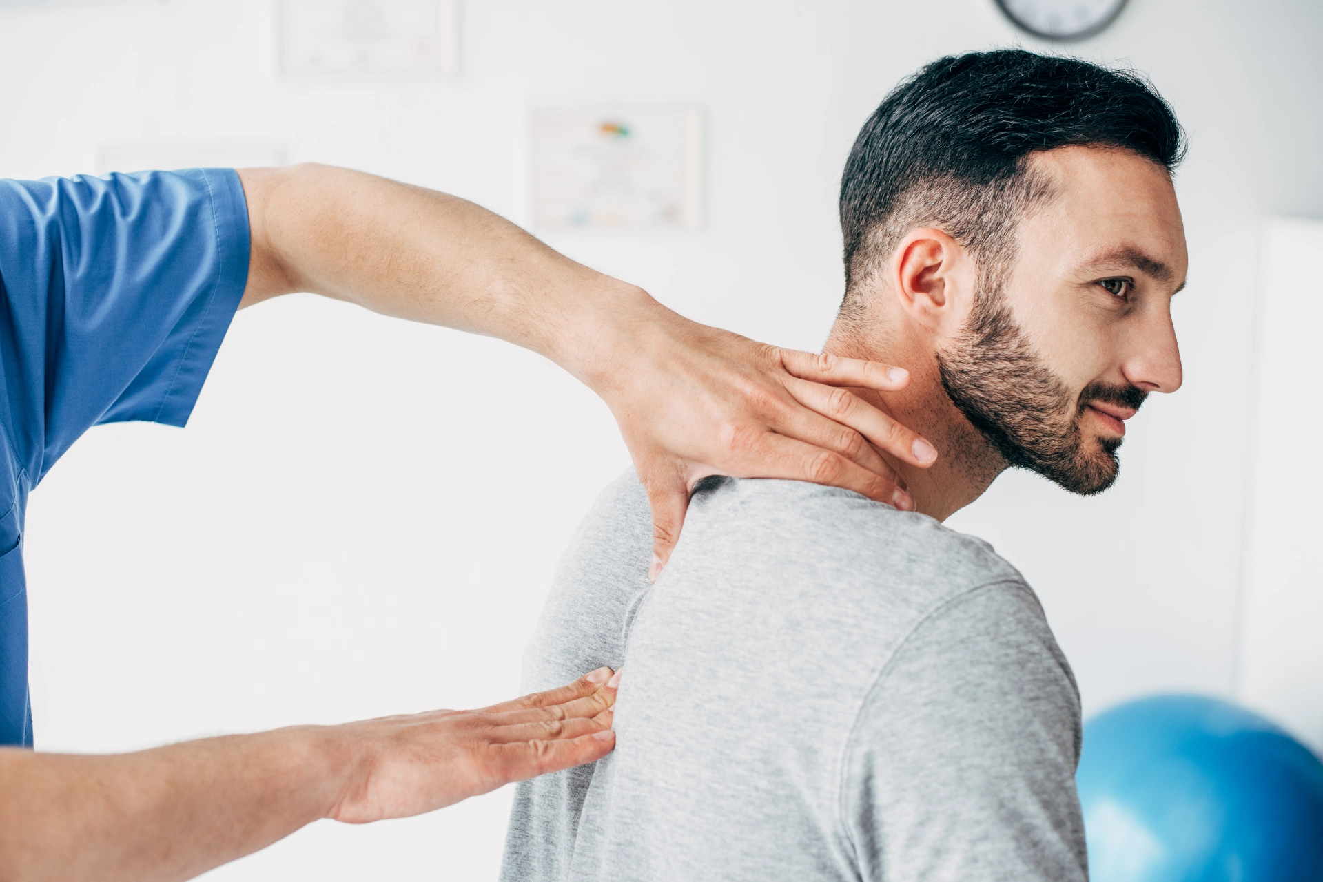 chiropractor massaging neck of good looking man in 2022 12 16 19 32 46 utc