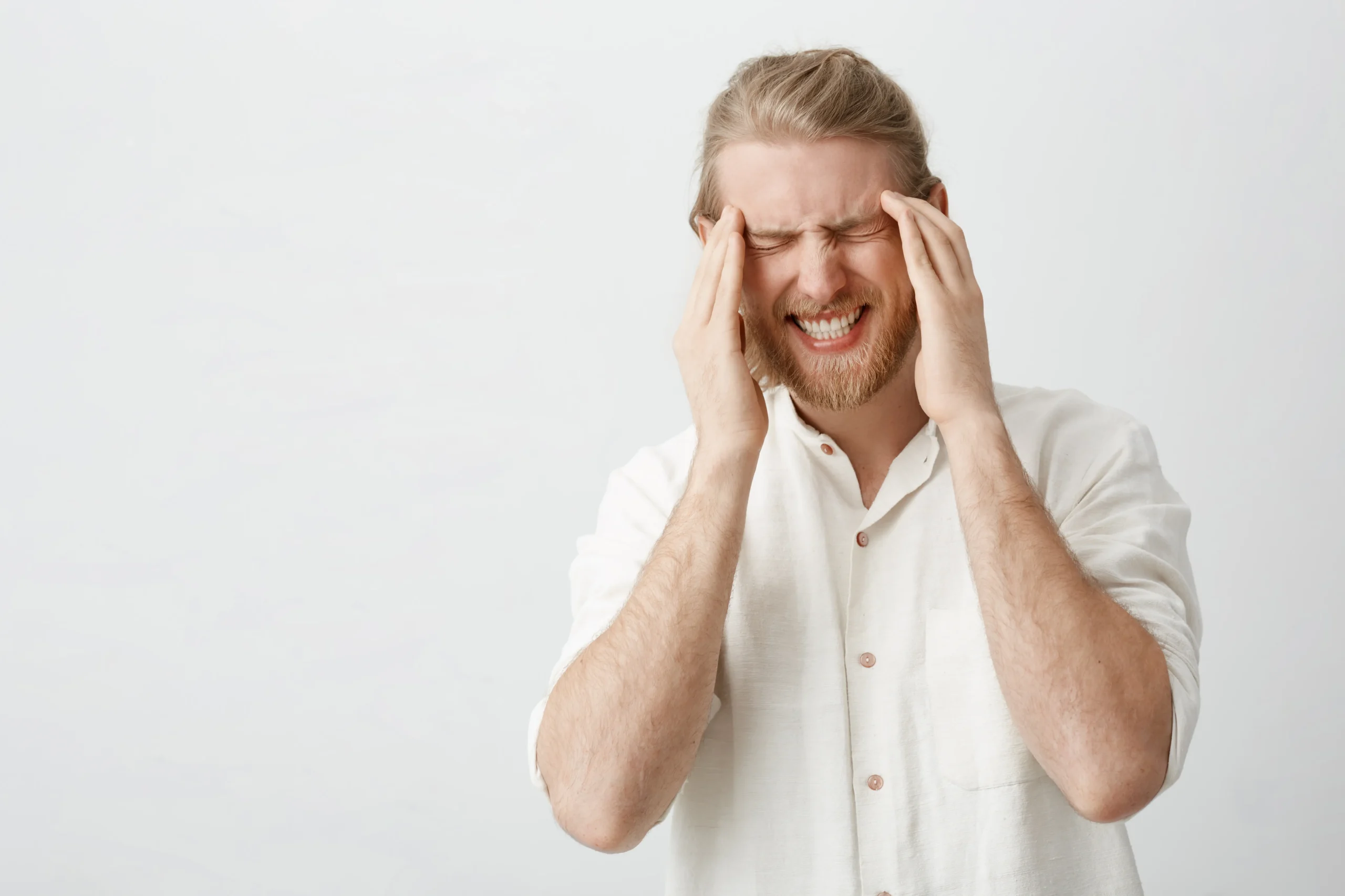 indoor-portrait-caucasian-blond-man-with-beard-suffering-from-migraine-headache-holding-fingers-temples